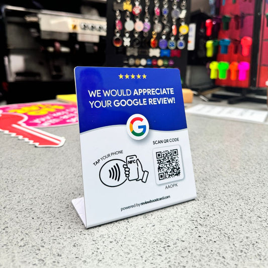 Google ReviewBoost stand displayed on a small business counter, inviting customers to easily leave a Google review by hovering their phone near the stand, enhancing the business's online visibility and customer engagement.